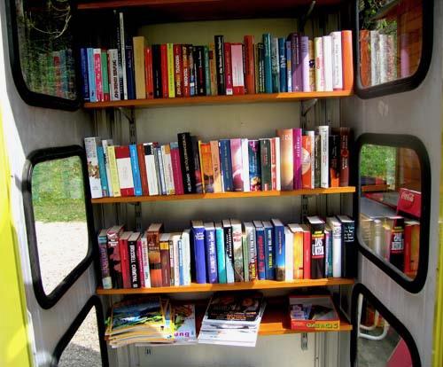 Eine alte Telefonzelle mit Büchern gefüllt